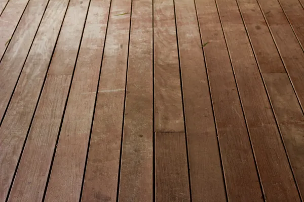 Close-up of pressure-treated wood deck boards with visible grain and screw heads