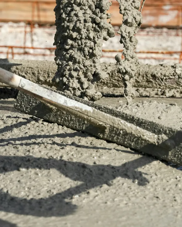 Concrete being screeded level over reinforcement