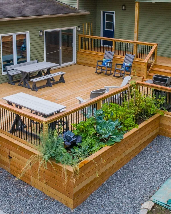 New pressure-treated wood deck with matching railing and built-in planters