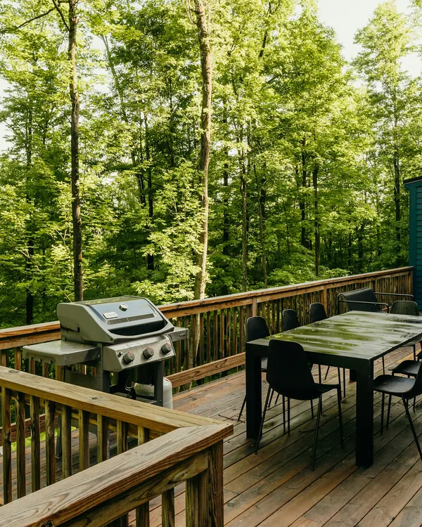 Rebuilt wood deck with railing, grill and dining table
